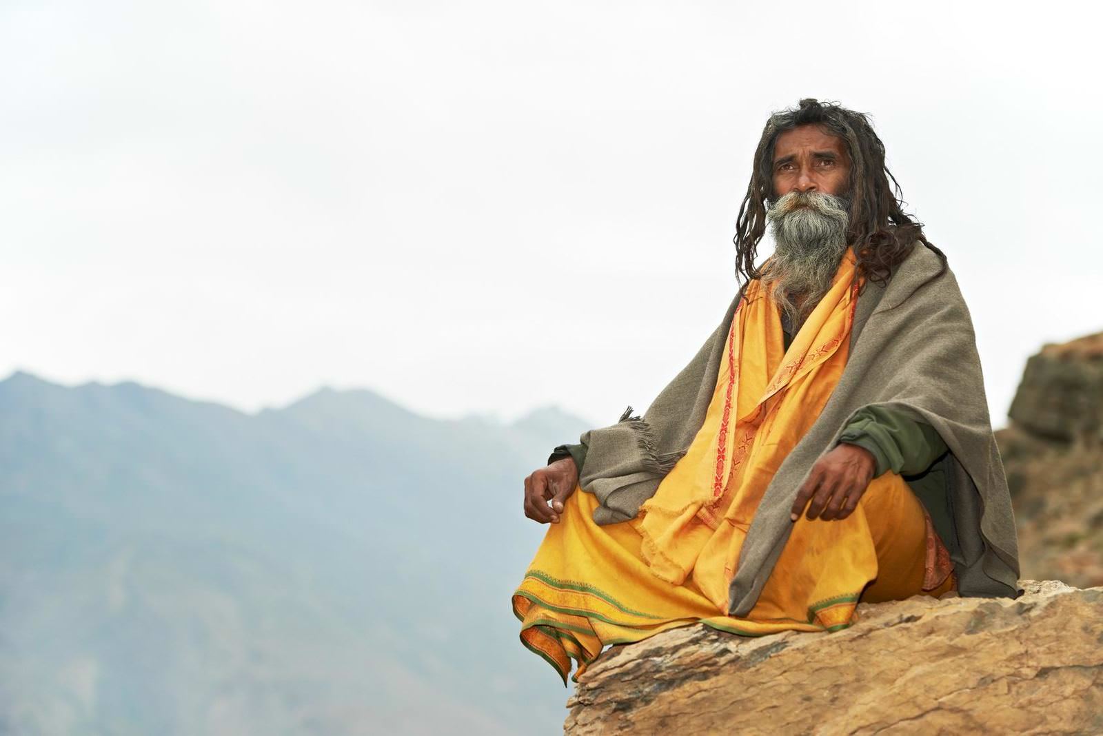 Indian old monk sadhu in saffron color clothing