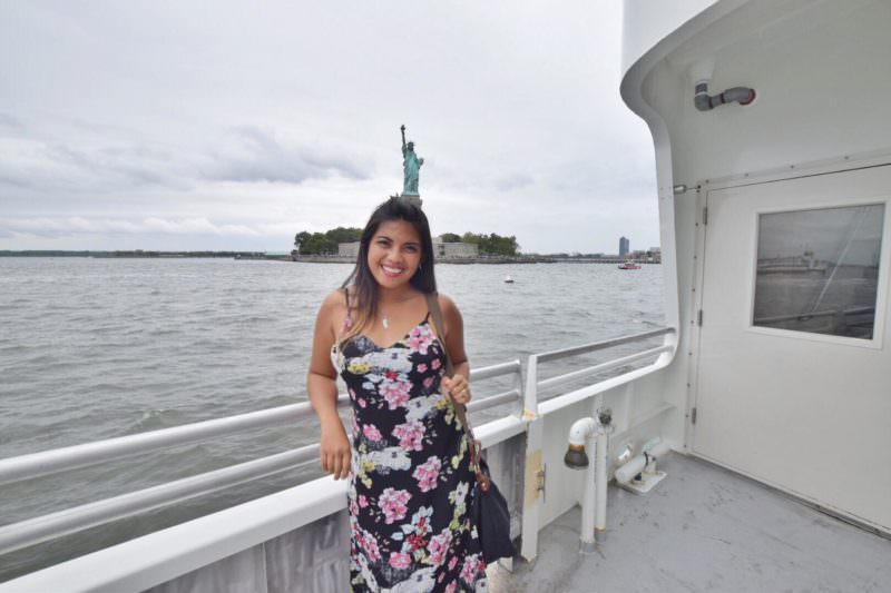 Kach posing by the railings by the sea