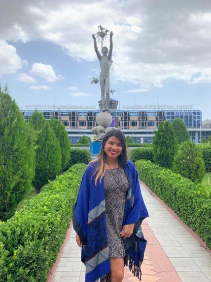 Kach standing in front of a monument