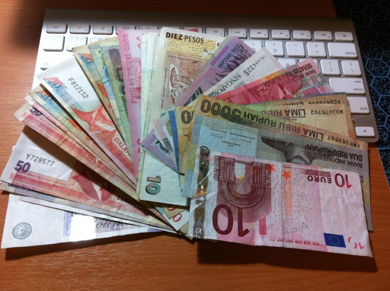 A notebook on the table with a few bills