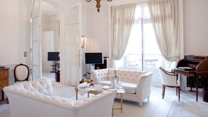 Grand hotel room with white furnishings and cozy setting