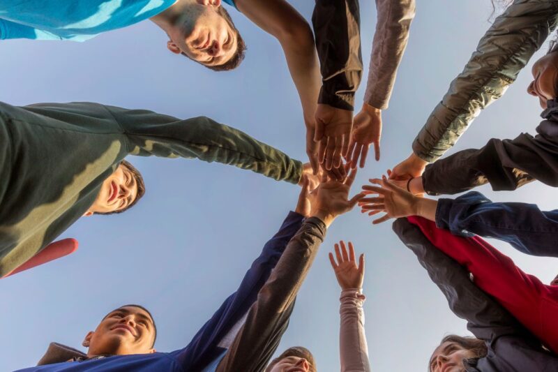 Community holding out hands for each other