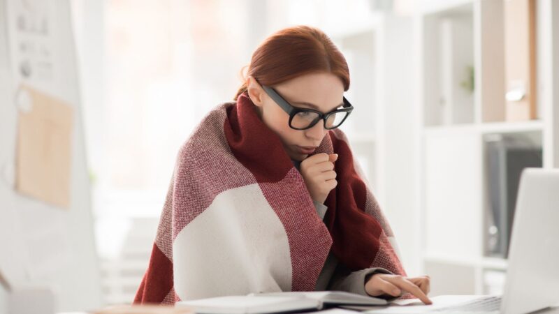 Girl wrapped in blanket while working