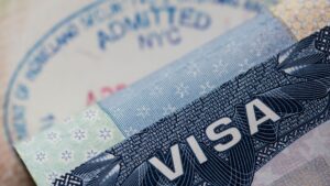 A visa put in front of a few documents and papers