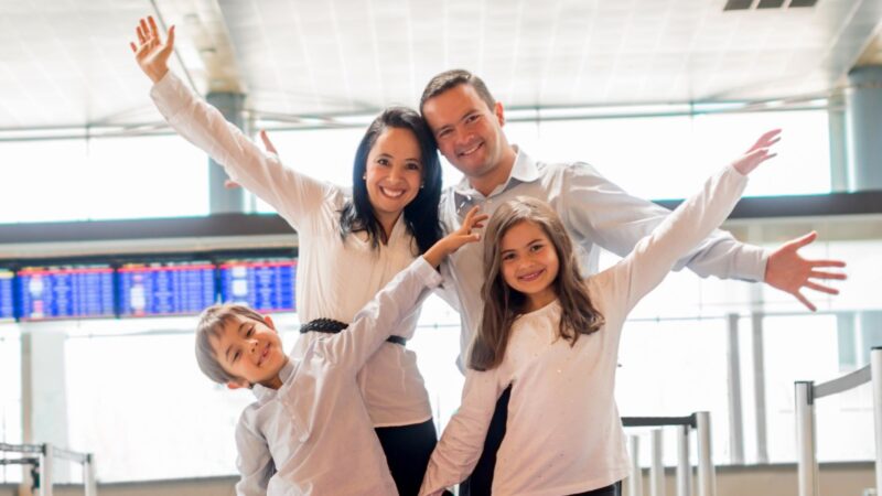 Family posing for a picture at the airport