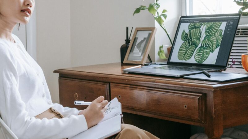 Woman with notebook on her lap writing something