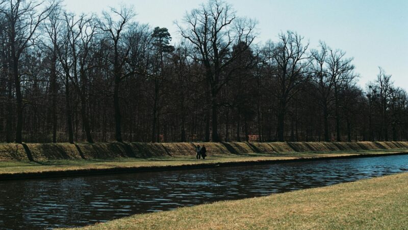 People walking along the banks of a river