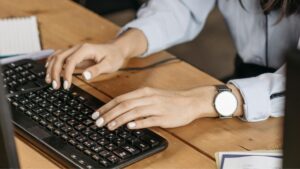 Hands typing something on the keyboard