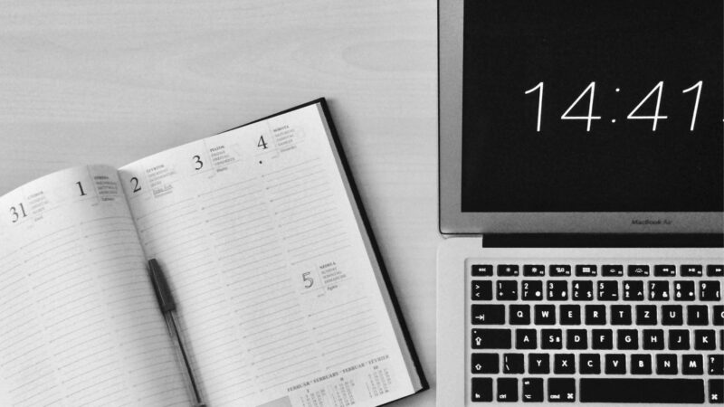 An open notebook beside the computer