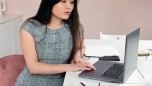 Woman at the table working on her laptop