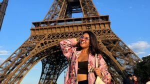 Woman in a floral jacket under Eiffel Tower