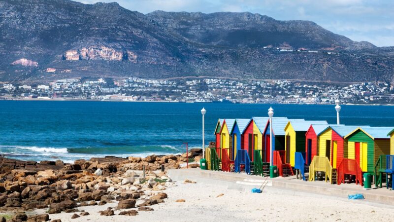 Brightly painted beach huts lined up on the sand