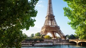 The Eiffel Tower seen through the green trees