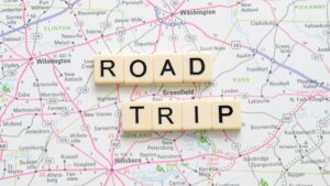 Scrabble pieces showing Road Trip on a map