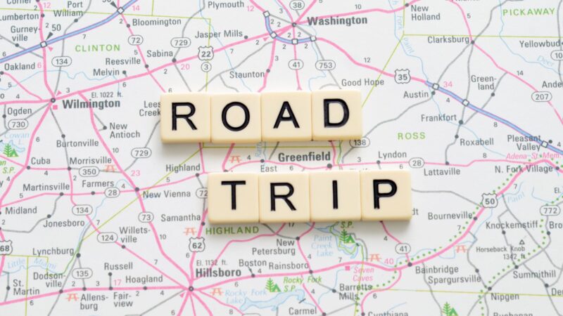 Scrabble pieces showing Road Trip on a map