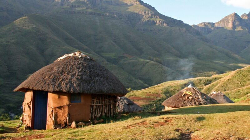 A small cottage by the mountains on a hillside
