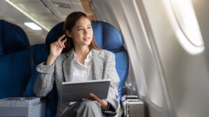 Woman in an airplane with a laptop on her lap