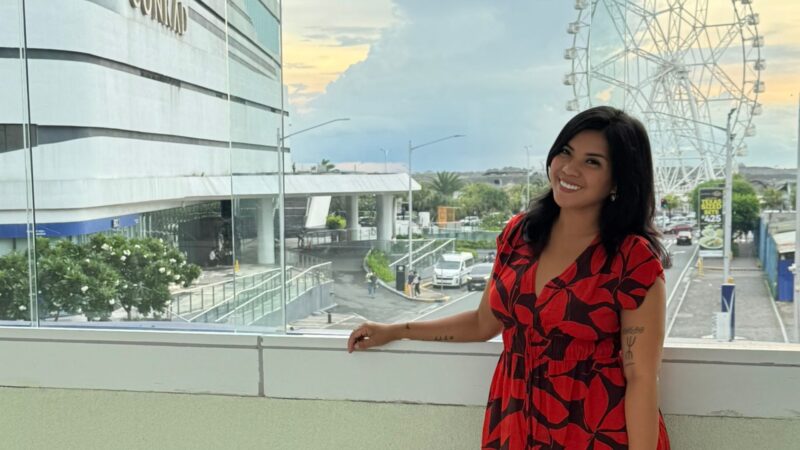 Kach near Conrad Manila with a ferris wheel behind her