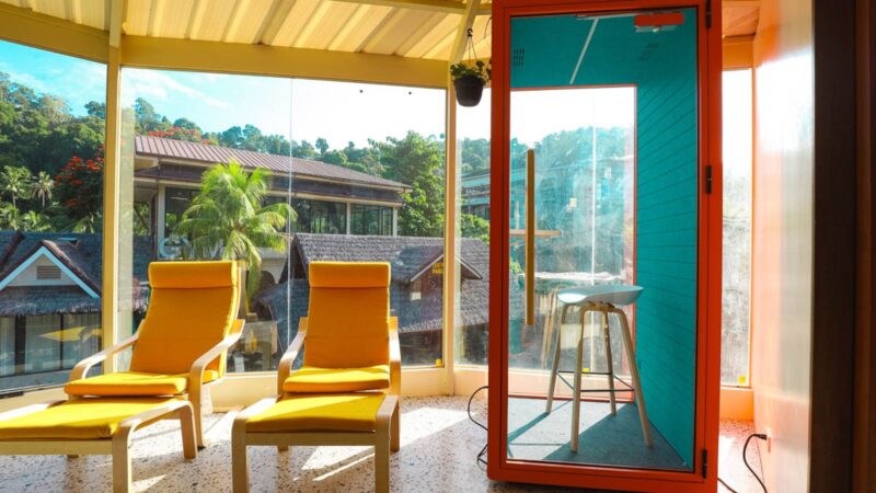 Coworking lounge with two relaxing chairs and phone booth