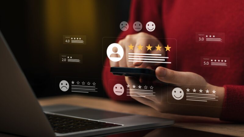 Person rating a service with five stars on a smartphone